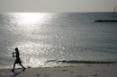 Manta Resort beach boy at sunset